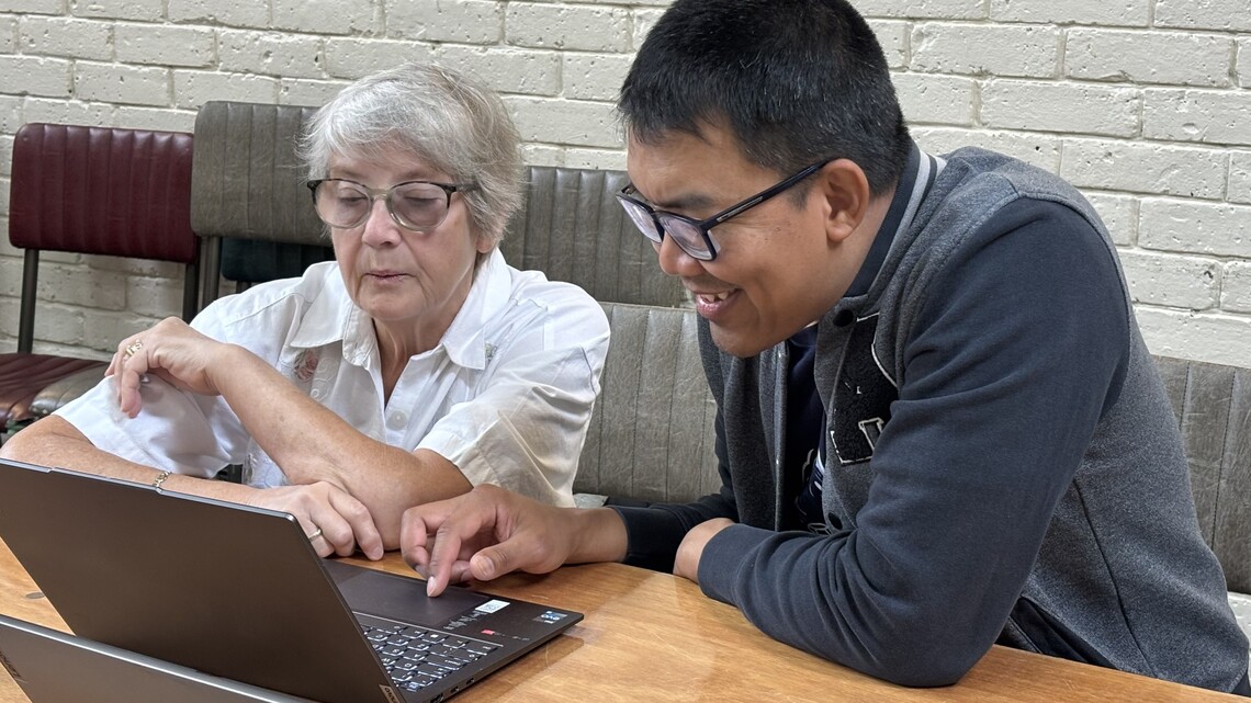 Nine sits with Christine. They're looking pretty engaged with what's on the laptop screen. Not surprising as they're installing Microsoft Office 2019