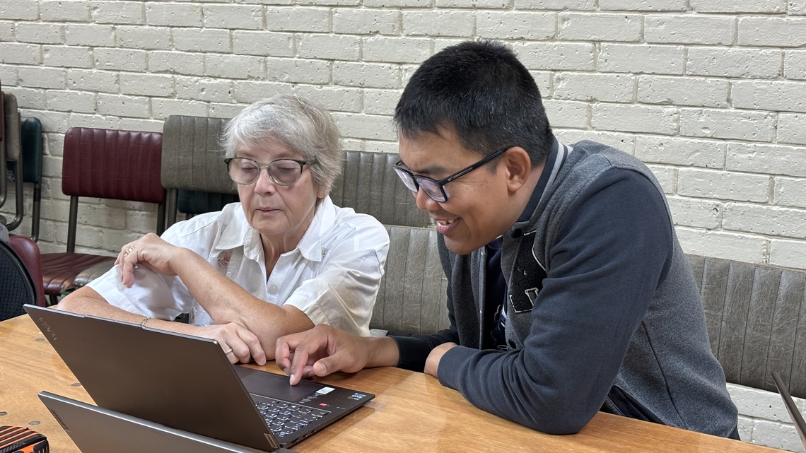 nine working with a participant at the bring your own tech day