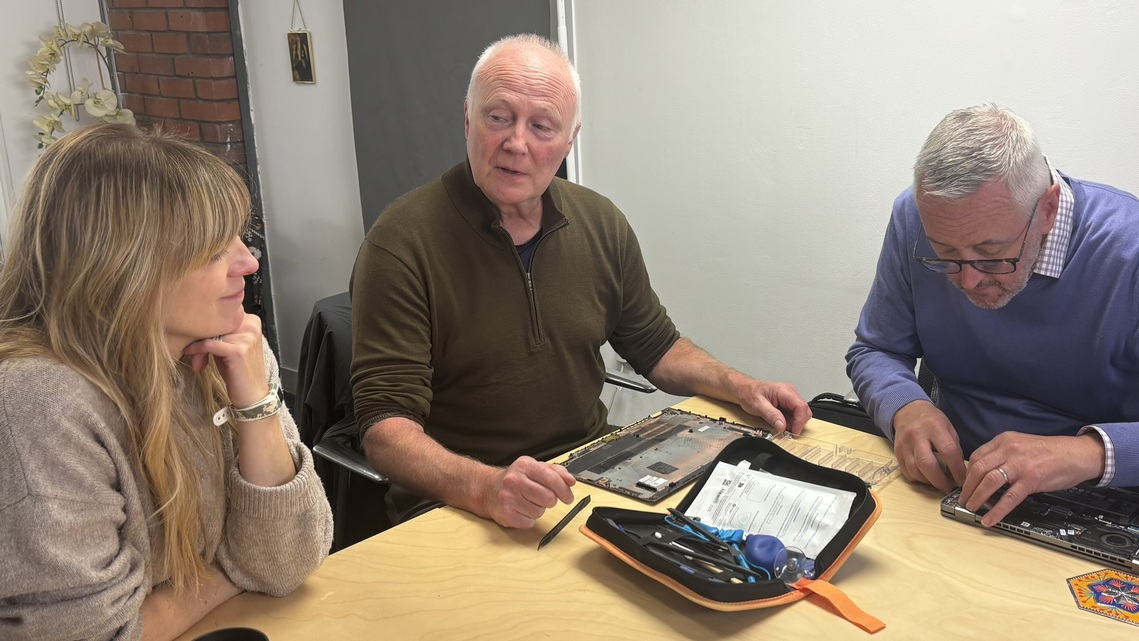paul and colin with attendee taking apart a laptop