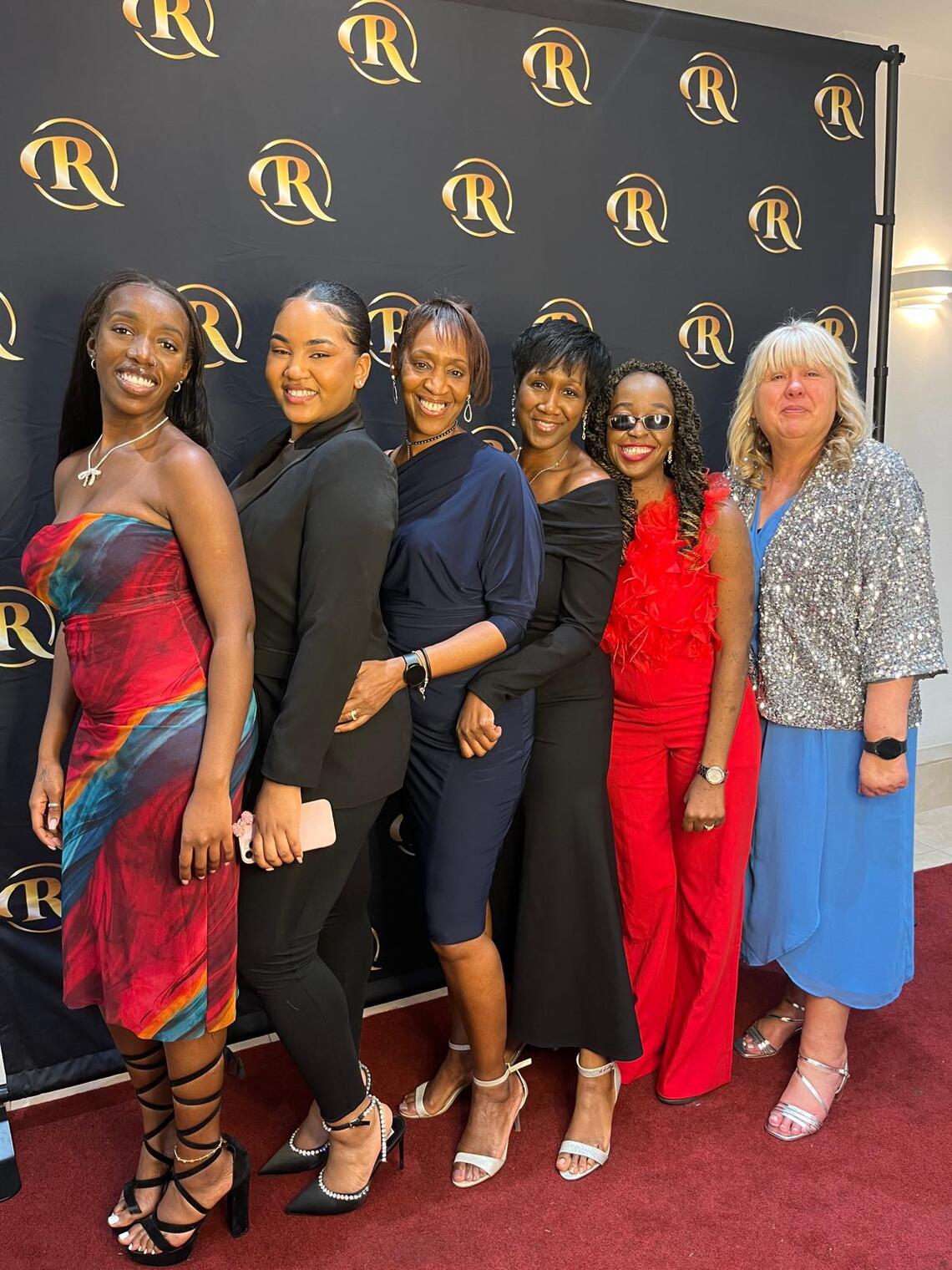 six members of precious counselling and mentoring standing in a line and smiling